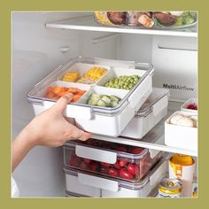 a person is reaching into an open refrigerator with food in containers on the shelves,