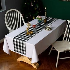 a table with two chairs and a black and white checkered tablecloth