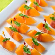 cantaloupe with mint garnish on a white plate