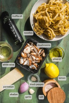 ingredients for pasta laid out on a wooden table with labels labeled in english and italian