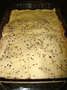 an uncooked casserole in a glass dish on the stove with lots of black seeds