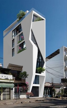 an unusual building with plants growing out of it's windows and balconies