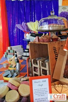 an assortment of desserts and pastries on display at a party or event with purple curtains