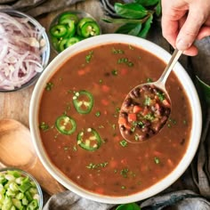 a spoonful of chili soup with beans and jalapenos