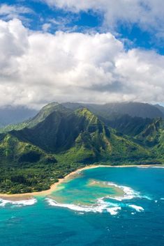 an aerial view of the ocean and mountains