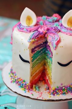 there is a cake that has been decorated with rainbows and sprinkles