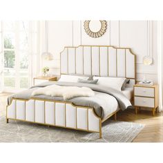 a white bed with gold frame and headboard