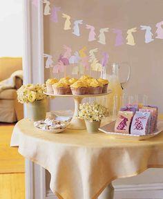 a table topped with cupcakes and muffins on top of a table