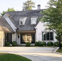 a white house with black shutters and windows