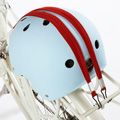 a helmet is attached to the back of a bicycle with red and white stripes on it