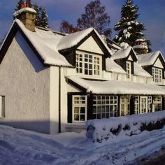 a house with snow on the roof and windows