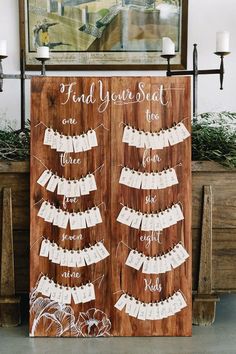 a wooden sign that says find your seat and place the names on it for guests