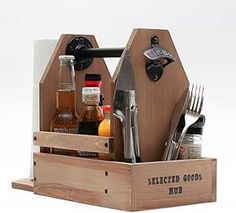 a wooden caddy with utensils and bottles in it that says sliced goods hob