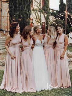 the bridesmaids are all dressed in pink dresses