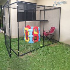 an outdoor play area in the grass with chairs and a net on top of it