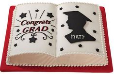 a book shaped cake with the words congrats grad and math on it