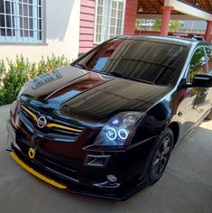 a black car parked in front of a house