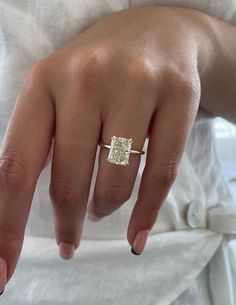 a woman's hand with a diamond ring on it