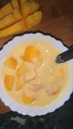 a bowl filled with cheese next to cut up carrots