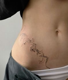 a woman's stomach with a tattoo on her belly and the bottom part of her body