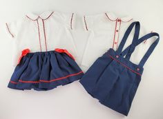 This classic stylish two-piece set includes a short-sleeve shirt elaborated in white Swiss dotted plumeti cotton. It features a nacar button front closure, a Peter Pan collar, and red rickrack trimmings. The suspender shorts are elaborated in a navy-blue pique cotton fabric with button side closures, elasticized pleated waistband and legs on the rear. Shorts feature a relaxed straight fit front waistband with a tuck on either side, red rickrack trimmings or red buttons, accomplish a dapper look. Summer School Cotton Sets, Summer Cotton School Sets, Preppy Cotton Sets For Spring, Preppy Cotton Spring Sets, Spring Preppy Cotton Sets, Summer School Sets With Short Sleeves, Fitted Summer School Sets, Cotton School Uniform Sets, Red Playwear Sets For Summer