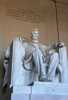 the lincoln memorial is shown in white marble and has a statue of abraham lincoln on it