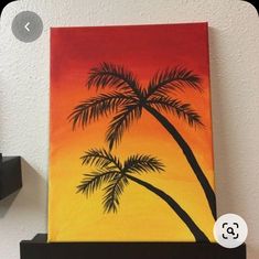 a painting of a palm tree on a shelf