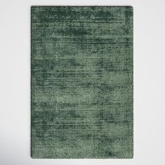 a green area rug on a white wall