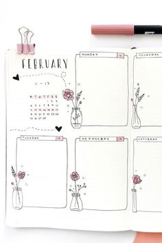 an open planner with flowers in vases on it and a pink pen next to it