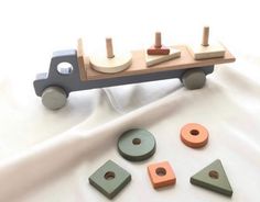 a wooden toy truck with four different shapes and sizes