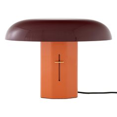 an orange table lamp with a brown shade on it's base and a black cord