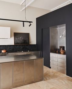 an industrial style kitchen with stainless steel appliances