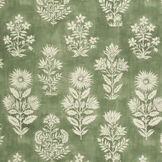 a green background with white flowers and leaves on the bottom half of it, as well as an area rug in the middle