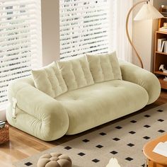 a living room filled with furniture and windows covered in blinds