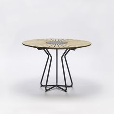 a wooden table with metal legs and a circular top on an isolated white background,