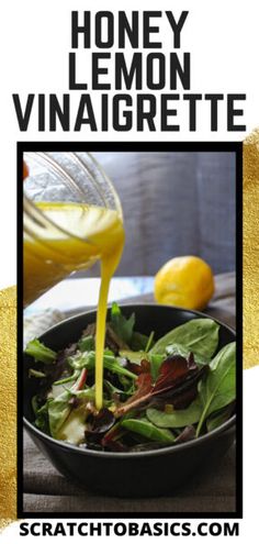 a bowl filled with greens and dressing next to a lemon wedge on top of a table