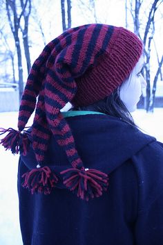 a woman wearing a hat and scarf in the snow