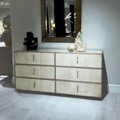 a white dresser topped with lots of drawers