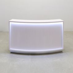 a large white counter sitting on top of a tiled floor next to a light colored wall