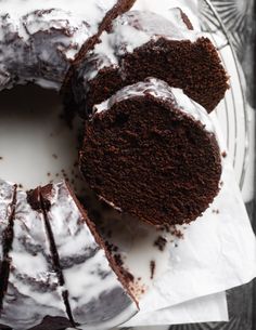 a chocolate bundt cake with white icing on a plate