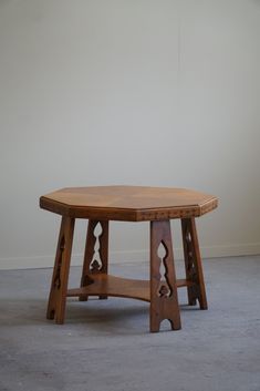 a wooden table sitting on top of a cement floor