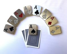 playing cards arranged in the shape of a circle on a white surface with one card missing