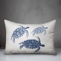 three sea turtles printed on a white pillow