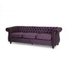 a purple couch sitting on top of a white floor