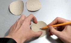 a person is cutting out circles with a pencil