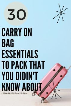 a pink piece of luggage sitting on top of a floor next to a blue wall