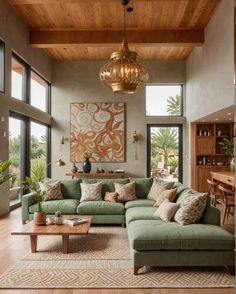 a living room filled with lots of furniture and large windows in front of the wall