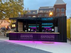 an outdoor stand with purple lighting on it