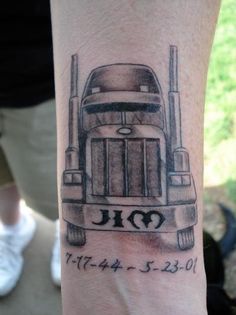 a tattoo on the arm of a man with a trucker's name and date