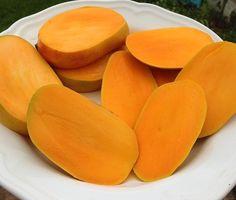 a white bowl filled with sliced up mangoes